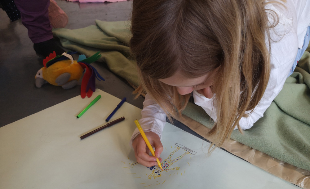 Girl drawing a poster during the School of Activism